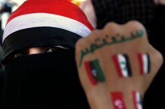 A Yemeni fully veiled youth, shows her f