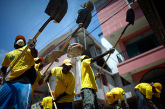 The U.S. Agency for International Development has contracted with relief groups to hire Haitians to clear rubble in the coastal city of Leogane. They also hope to get locals involved in the rebuilding process.
