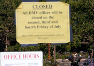 A California Department of Motor Vehicles customer looks at a closed sign posted on the door of a DMV branch July 10, 2009 in Corte Madera, California.