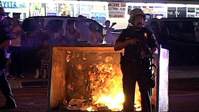 Police work to quell a disturbance sparked by a fatal police shooting in Anaheim on Saturday, July 21, 2012.