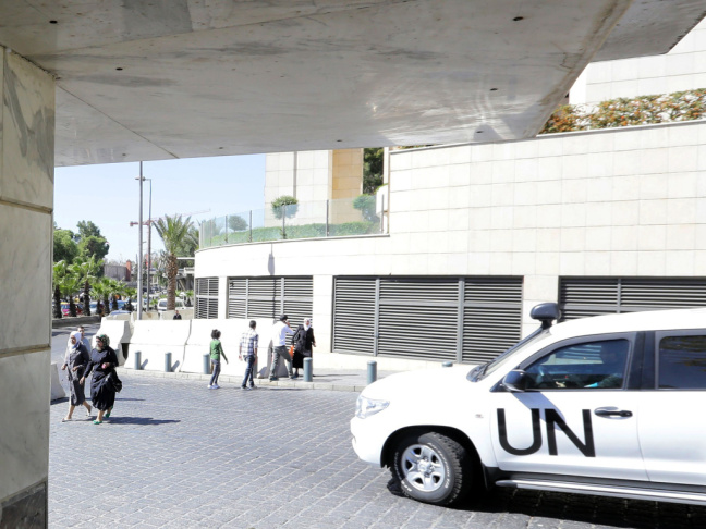 A United Nations vehicle carrying inspectors from the Organization for the Prohibition of Chemical Weapons (OPCW) leaves a hotel in Damascus, on Wednesday. Some 19 OPCW arms experts are in Syria and have started to destroy weapons production facilities.