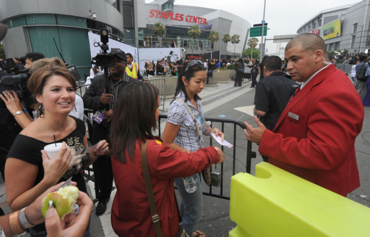 Fans who have tickets pass through a bar