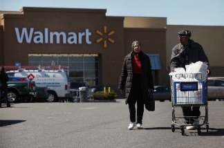 Shoppers exit a Walmart store on March 29, 2011 in Valley Stream, New York.