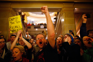 Protesters react to an appearance by Republican Gov. Scott Walker at a news conference inside the Wisconsin State Capitol February 21, 2011 in Madison, Wisconsin.