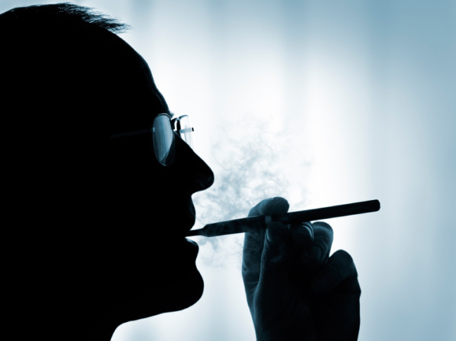 A man smokes an electronic cigarette.
