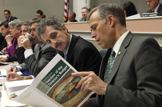 Assembly members Mike Feuer, D-Monterey Park, left and Jared Huffman, D-San Rafael, look over a copy of the Legislative Analyst's report on Gov. Jerry Brown's proposed 2011-12 budget, during a hearing of the Assembly budget committee at the Capitol in Sacramento, Calif., Thursday, Jan. 13, 2011. Lawmakers began going through Brown's proposed $84.6 billion general fund spending plan that contains taxes, cuts and major government restructoring to try to fill an estimated $25.4 billion budget gap.