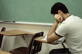 A student reads in the classroom.