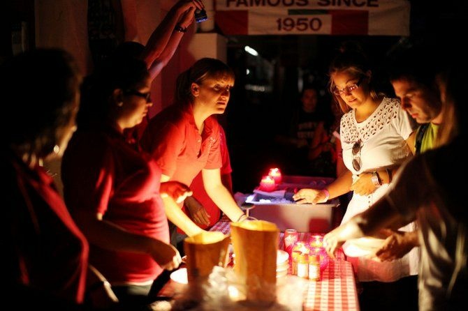 Workers serve pizza to customers outside of Filippi's Pizza after a massive blackout hit Southern California September 8, 2011 in San Diego, California.