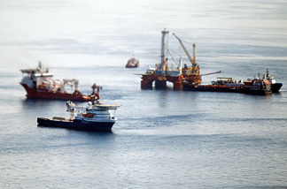 Ships work near the site of the BP Deepwater Horizon oil spill on August 3, 2010 in the Gulf of Mexico off the coast of Louisiana.