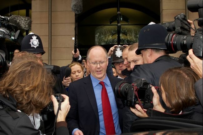 Former BBC Director general George Entwistle surrounded by photographers.