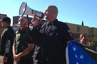 Water board candidate and white supremacist Jeff Hall (with bullhorn) at an anti-illegal immigration rally in Riverside last year.