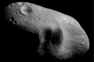 An image mosaic of the asteroid Eros, with sunlight coming from the northeast, taken by the robotic NEAR Shoemaker space probe.
