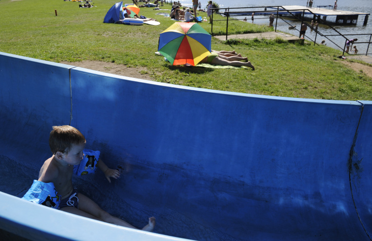 A boy slides down in a tobogan as he enj