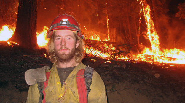 Firefighter John Lauer, seen at the scene of a wildfire in Montana, led a campaign for health coverage of seasonal firefighters and their families.