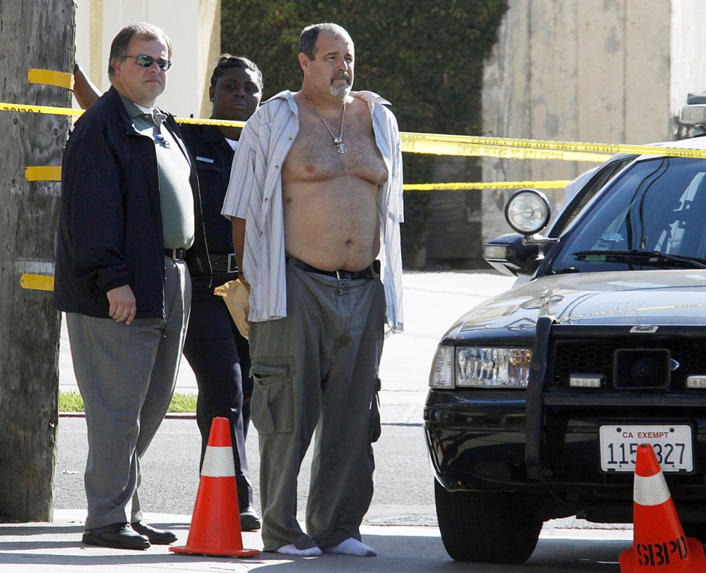 Police officers stand with Scott Evans Dekraai near the Salon Meritage in Seal Beach on Oct. 12, 2011. Dekraai is charged with eight counts of murder, the worst mass killing in Orange County history.