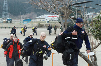 US and British relief staff arrive for rescue operations in the town of Sumita in Iwate prefecture on March 14, 2011 three days after a massive 8.9 magnitude earthquake and tsunami devastated the coast of eastern Japan.