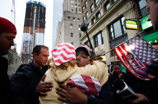 Dionne Layne, facing camera, hugs Mary Power as they react to the news of the death of Osama bin Laden, Monday, May 2, 2011 in New York. At left is the rising tower, 1 World Trade Center, also known as the Freedom Tower.