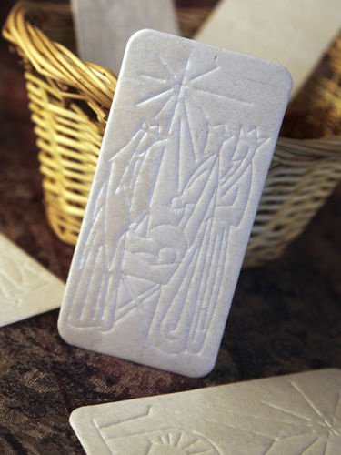 The oplatek, embossed with a Christmas scene, is shared among family members before Christmas Eve dinner.