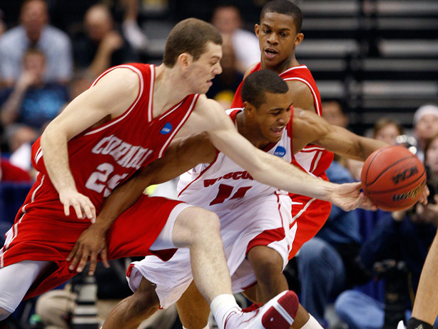 Cornell's Jon Jaques (25) and Wisconsin's Jordan Taylor go after a loose ball.