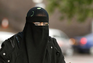 A woman wears a full face Niqab on the streets July 20, 2010 in Blackburn, England. Syria has banned the wearing of full face veils in its universities.