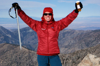Cindy Abbott holds an ice axe and a medication bottle while on the summit of Mt. Baldy, Calif.