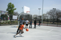 Kids play basketball on a court at the Martin Luther King park at Western Avenue and 39th Street in south Los Angeles.