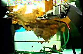 A robotic arm from a submersible works around the leaking Gulf of Mexico wellhead in this still image from a live BP video feed.