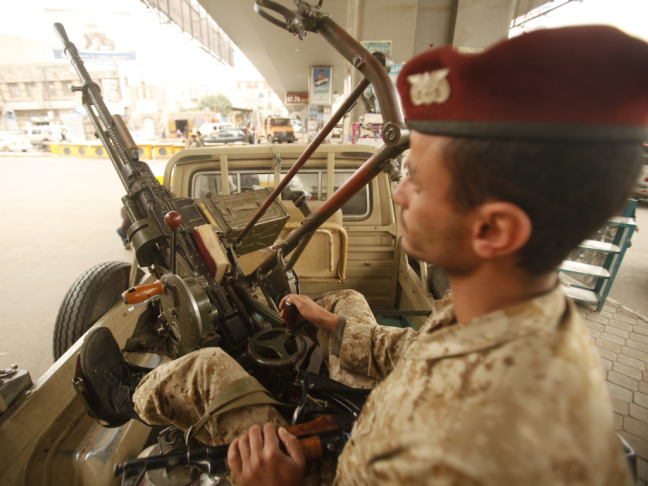 An army trooper sits beside a machine gun that is mounted on a patrol vehicle at a checkpoint in Sanaa, Yemen. Security is tight in the capital amid warnings about possible terrorist attacks.