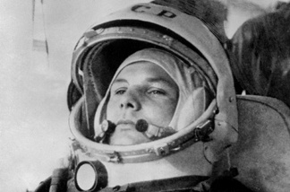 Yuri Gagarin, 27, (1934-68) wearing cosmonaut helmet, prepares to board Soviet Vostok I spaceship 12 April 1961 at Baikonur rockets launch pad shortly before its take-off to became the first man to travel in space, completing a round-the-Earth circuit.