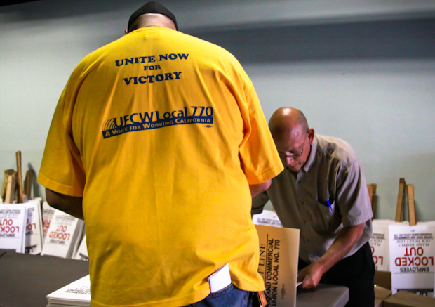 Grocery workers assemble picket signs at the Local 770 headquarters in Los Angeles ahead of a possible strike.