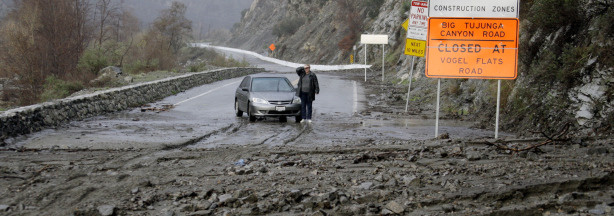 Big Tujunga Canyon resident Rhonda Keermann views the area where several feet of mud has blocked Big Tujunga Canyon Road, preventing her from leaving, in the Tujunga area of Los Angeles Tuesday, Jan. 19, 2010. A skiploader later cleared an area for her to pass. Several inches of rain have fallen and more rain is predicted as a series of storms move through California.