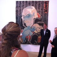 Artist Masami Teraoka explains his AIDS Series painting at Samuel Freeman Gallery as Sam Freeman looks on. 9/11/12. 