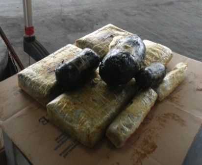 Packages of heroin and methamphetamine found in a non-factory compartment within the undercarriage of a Mazda are shown. In a separate case, a Texas trooper found bundles with more than 6 pounds of heroin in the passenger side rocker panel of a California man's vehicle.