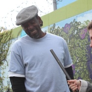 Alex Cohen interviews Ron Finley right next to his sidewalk garden.