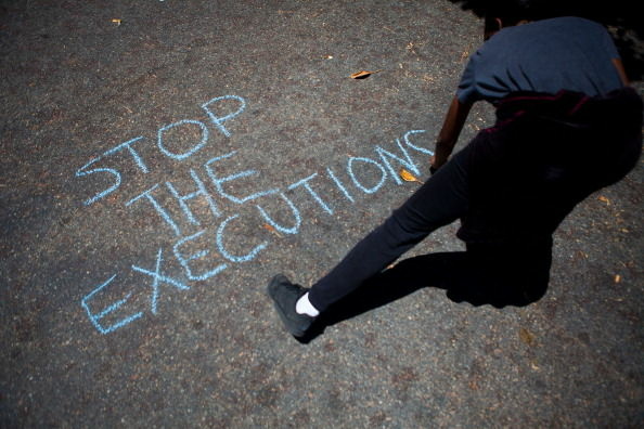 A protester writes a message for the Orange County Police during a demonstration to show outrage for the several recent officer involved shootings on July 29, 2012 in Anaheim, California.