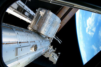 In this handout image provided by NASA, backdropped by the blackness of space and Earth's horizon, the Japanese Kibo complex of the International Space Station is seen while space shuttle Discovery remains docked with the station February 26, 2011 in space.