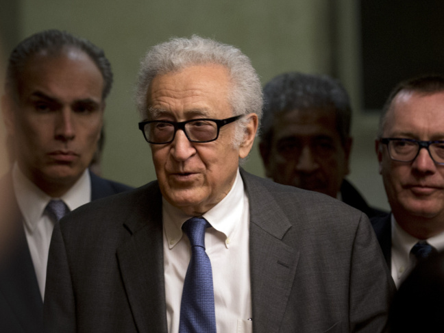 U.N. mediator Lakhdar Brahimi, center, arrives for a press briefing at the United Nations headquarters in Geneva, Switzerland on Saturday.