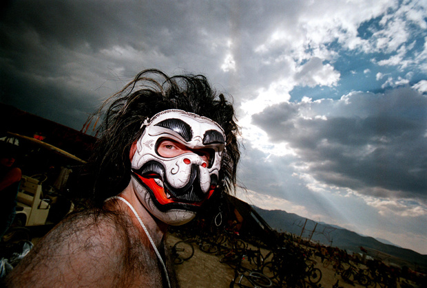 A man wearing an animal mask glances at the camera during the15th annual Burning Man festival September 2, 2000 in the Black Rock Desert near Gerlach, Nevada.