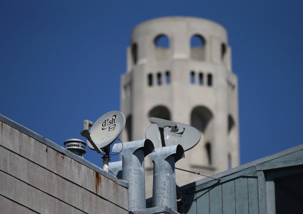 A Dish Network satellite dish (L) is mounted next to a DirecTV dish on the roof of an apartment building on April 15, 2013 in San Francisco, California.