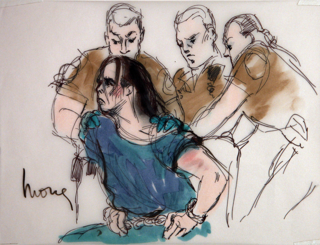 In this courtroom sketch, Harry Burkhart, a native of Germany who has been living in Los Angeles and is suspected in a series of arson fires, is restrained by guards as he alternately tries to stand and sit during his arraignment in Los Angeles Superior Court, Wednesday, Jan. 4, 2012 in Los Angeles. Burkhart was charged with 37 counts of arson in connection with a rash of fires that terrorized Los Angeles over the New Year's weekend. (AP Photo/Mona Shafer Edwards)