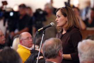 Geisha Williams, center, senior VP of Energy Delivery for Pacific Gas & Electric, spoke to hundreds of displaced San Bruno residents that jammed a town hall meeting at St. Roberts Catholic Church in San Bruno, Calif., Saturday, Sept. 11, 2010. Fire crews doused the remnants of an enormous blaze and accounted for the residents of dozens of homes Friday after a gas line ruptured and an explosion ripped through in a neighborhood near San Francisco, killing at least six people.
