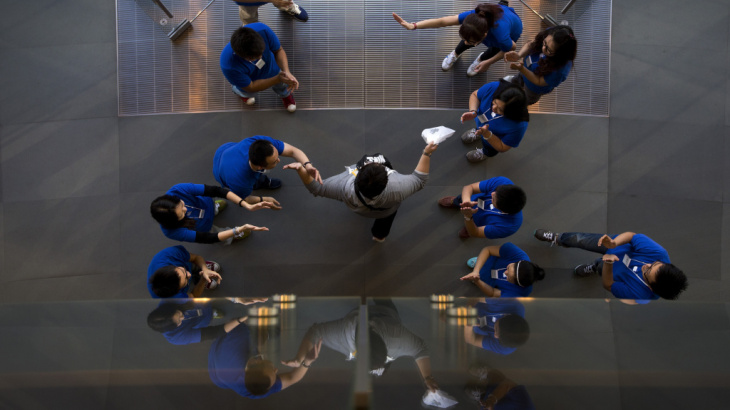 Apple says it has sold 9 million iPhone 5s and 5c models since their launch on Friday. Here, staff at an Apple retail store in Beijing cheer a customer after he bought a new iPhone.