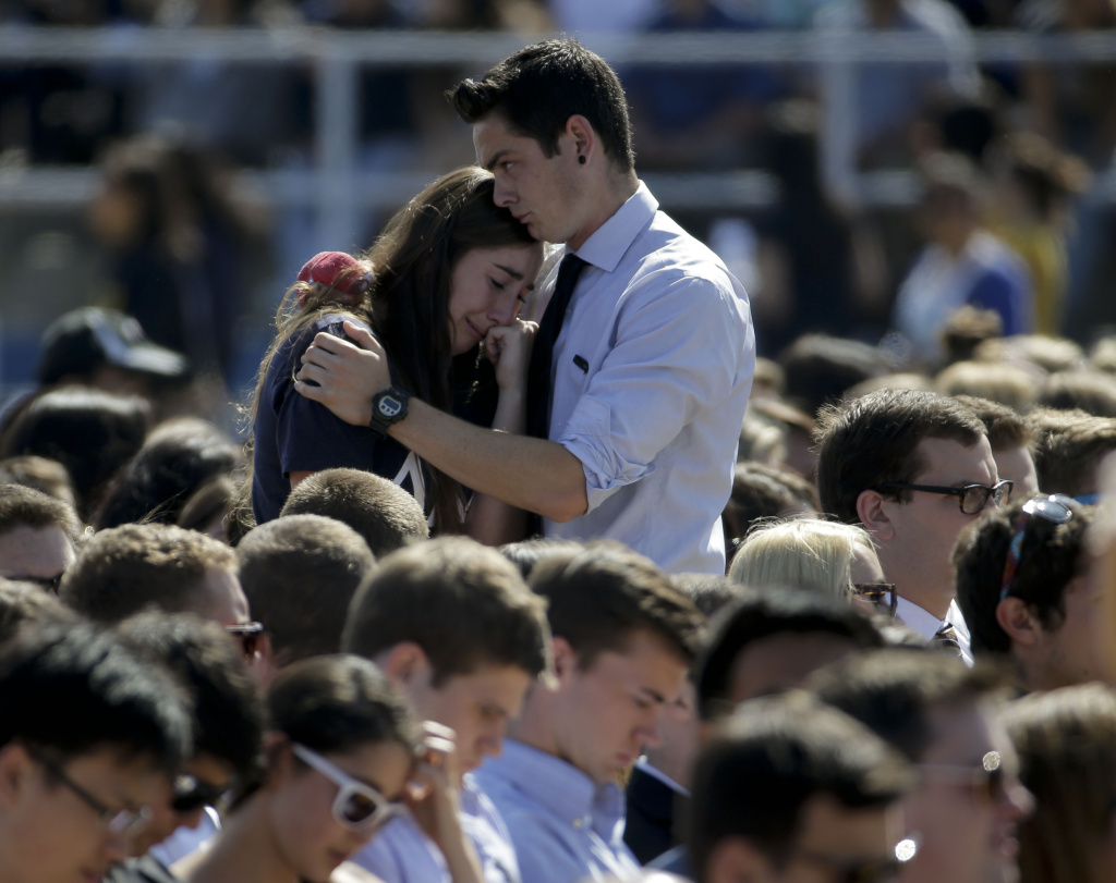 A couple embrace before a memorial service for the victims and families of Friday's rampage at Harder Stadium on the campus of University of California, Santa Barbara on Tuesday, May 27, 2014 in the Isla Vista area near Goleta, California.