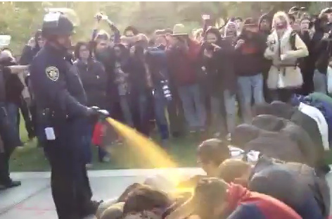Police at the University of California, Davis campus use pepper spray on a group of protesters as they attempt to clear an Occupy encampment from the school.