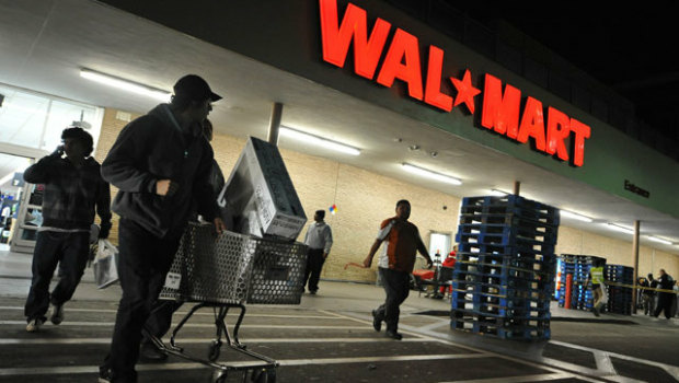 Wal-Mart shoppers make their way home in the early morning hours Friday.