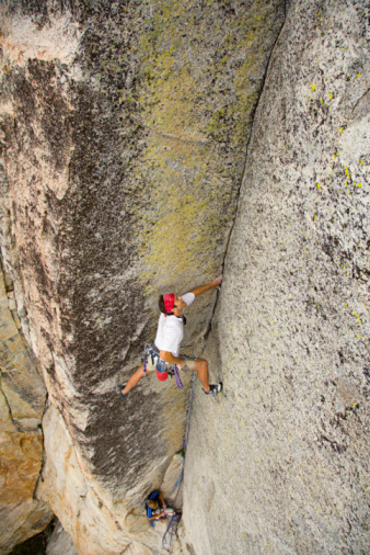 Man rock climbing at Tahquitz Rock in Idyllwild, CA. Tahquitz Rock is where the demon's spirit is said to have flown after he was killed and burned with "green wood."