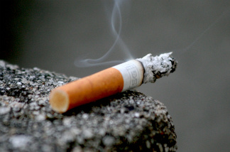 Posted signs will prevent cigarettes like this on the patios of Long Beach restaurants and bars.