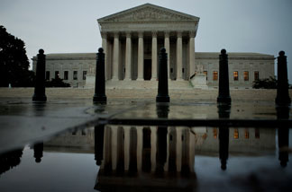 The US Supreme Court building is reflected in water August 5, 2010 in Washington, DC.