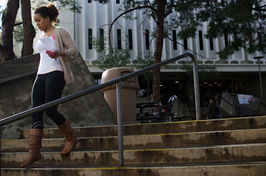 Gabrielle Dewberry runs to class with her assignment in hand at Cal State-Fullerton.