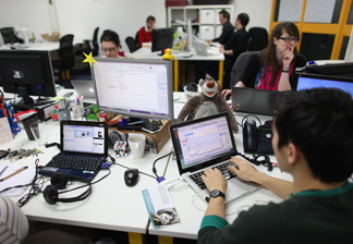 People work at computers in TechHub, an office space for technology start-up entrepreneurs in London, England.